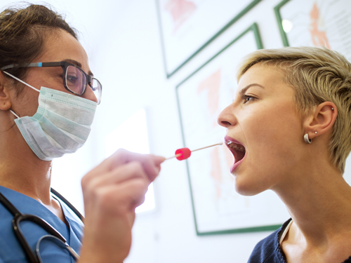 Nurse swabbing a patient's mouth