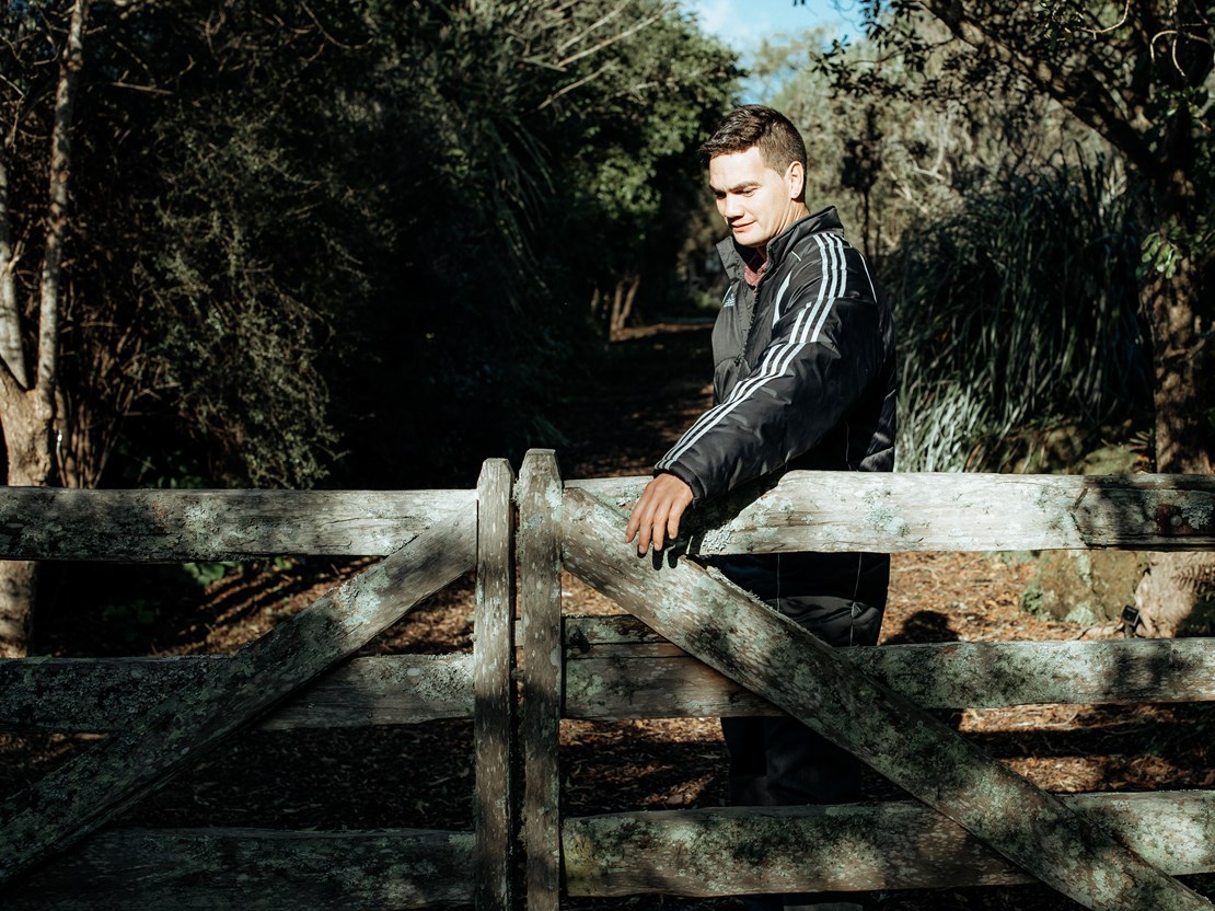 Adult man with ASD opening a barn gate