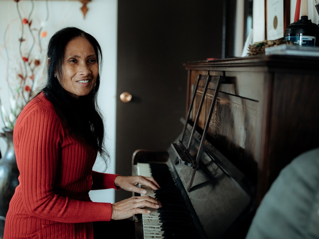 Jackie has vision impairment and is playing the piano