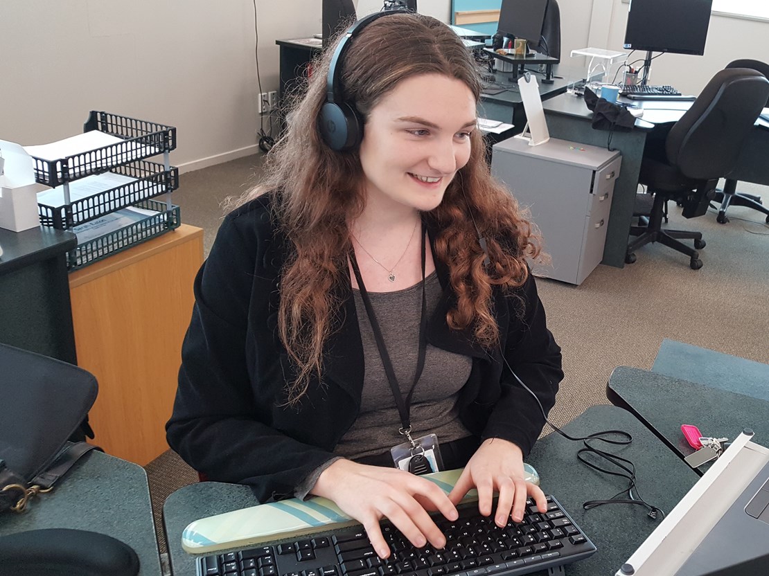 A support facilitator wearing a headset 