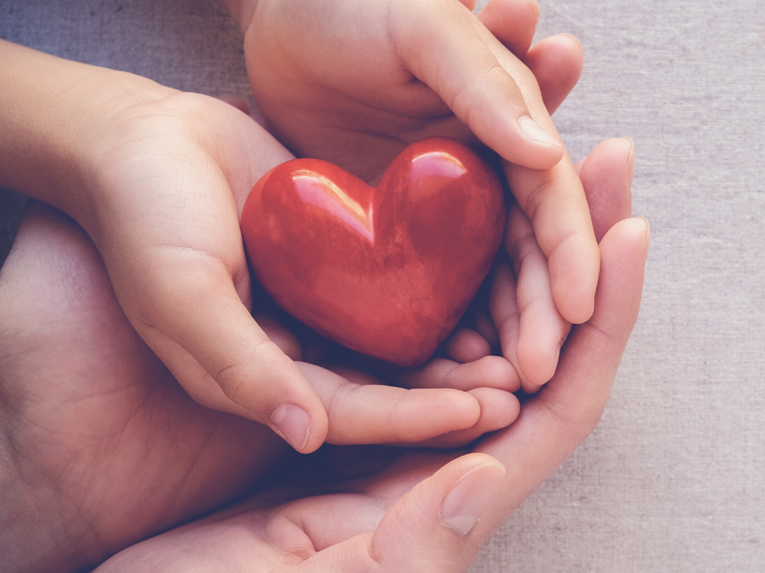 Hands holding a ceramic heart