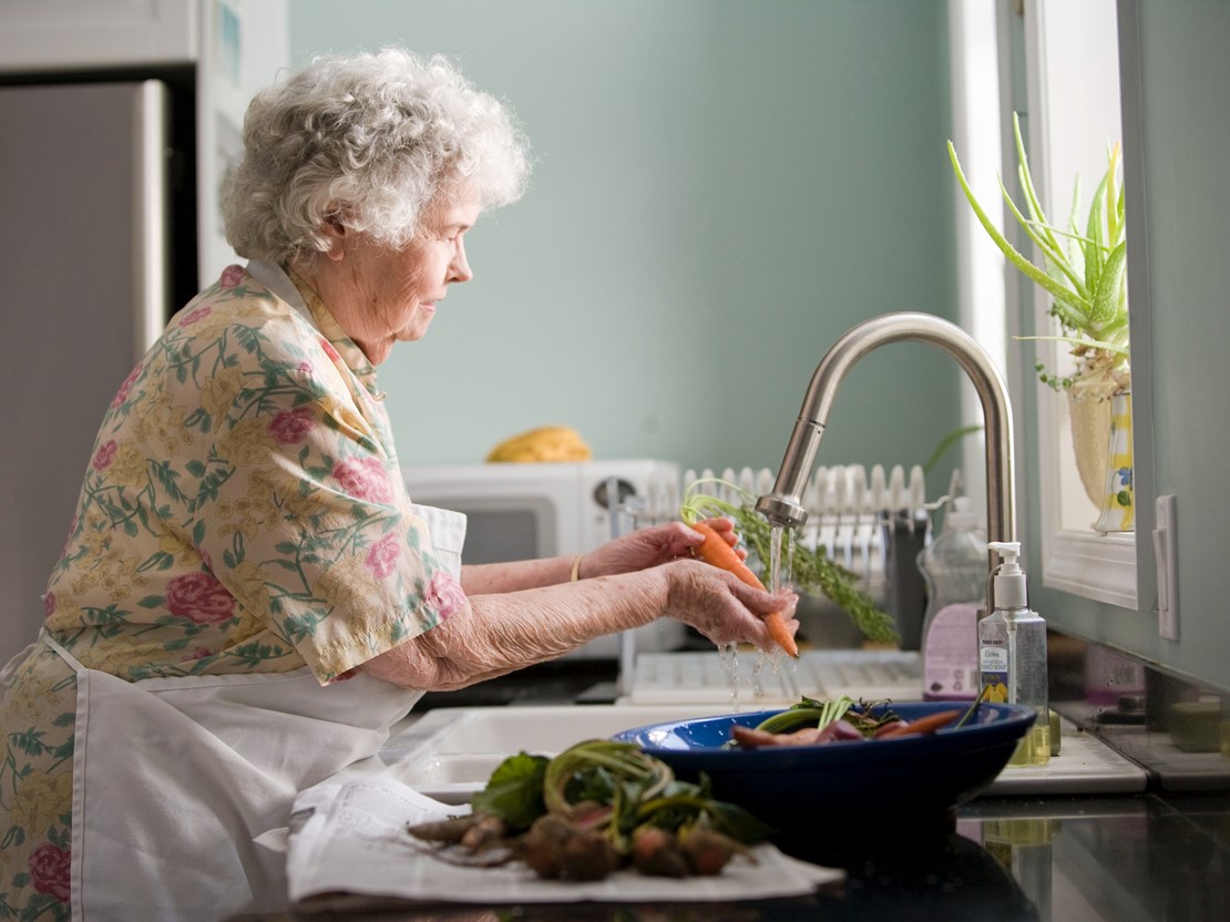 Elderly woman washing dishes.jpg