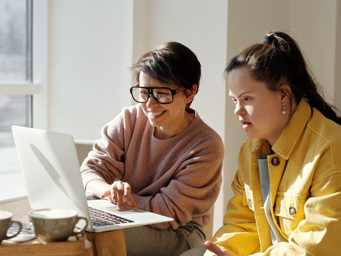 Two young people working on a laptop