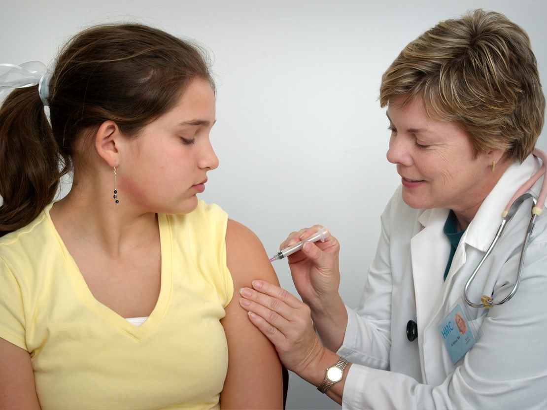 Teenager getting vaccinated