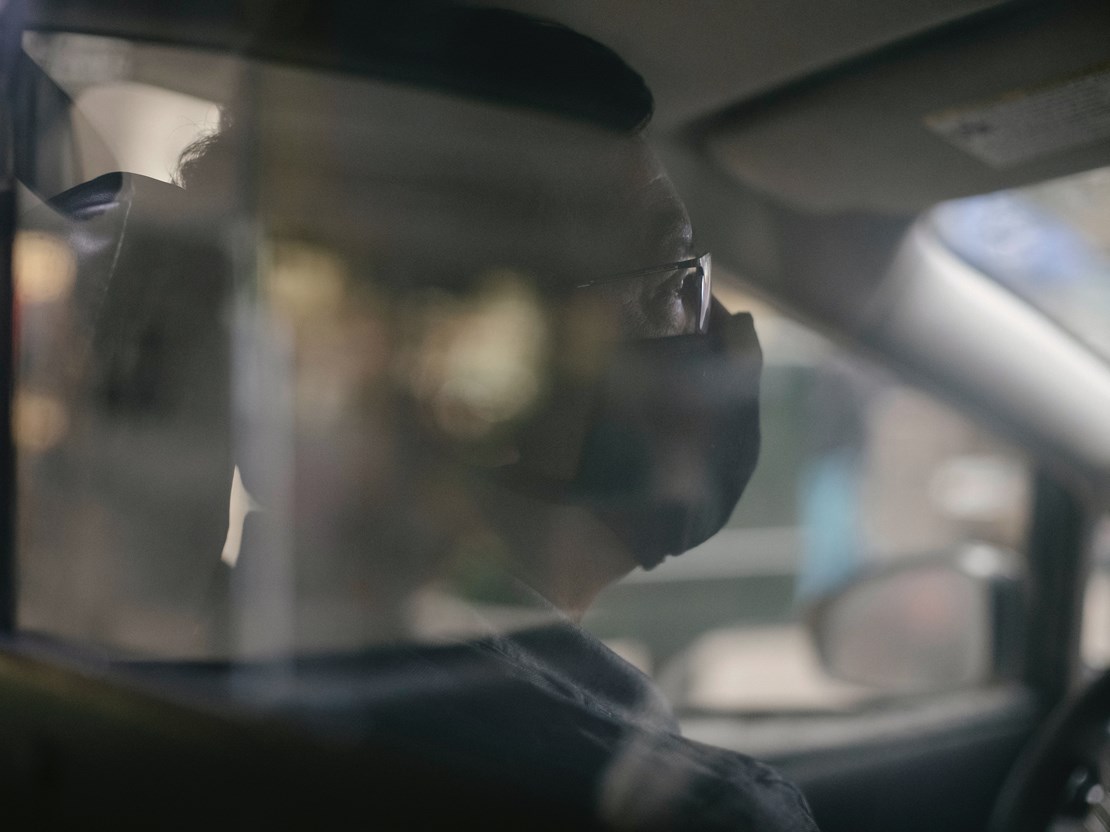 Man wearing face mask in car 