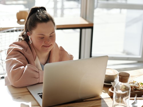 Young person with Downs Syndrome using a laptop.jpg