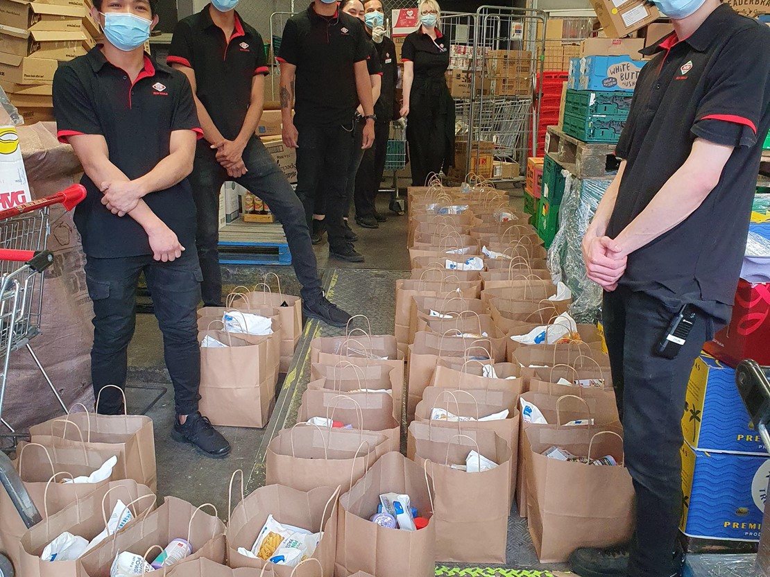 New World grocery team with bags of food parcels